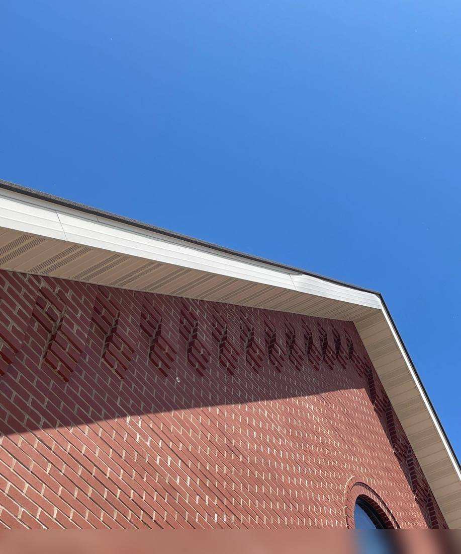 Brick gable and shingle roof of St. Stanislaus Kostka Church, photographed during a roof inspection, May 2022