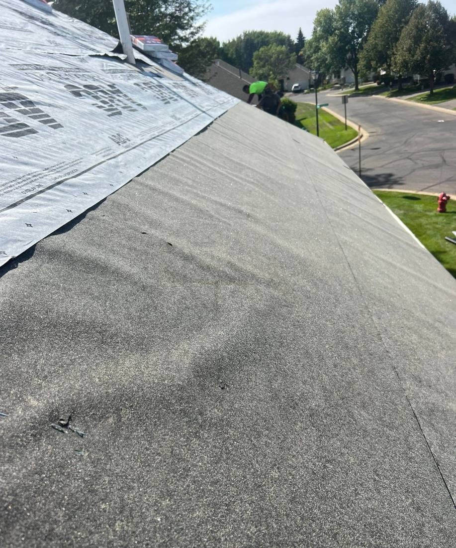New synthetic underlayment going down on an Apple Valley re-roof, August 2023