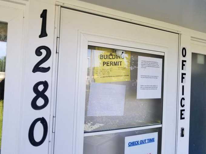 City of Newport building permit posted on the Red Rock Lodge office door at 1280 Hastings Avenue during the Repair King re-roof