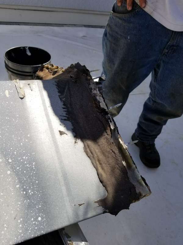 Old metal flashing removed during the Duro-Last installation at the Forest Lake dealership