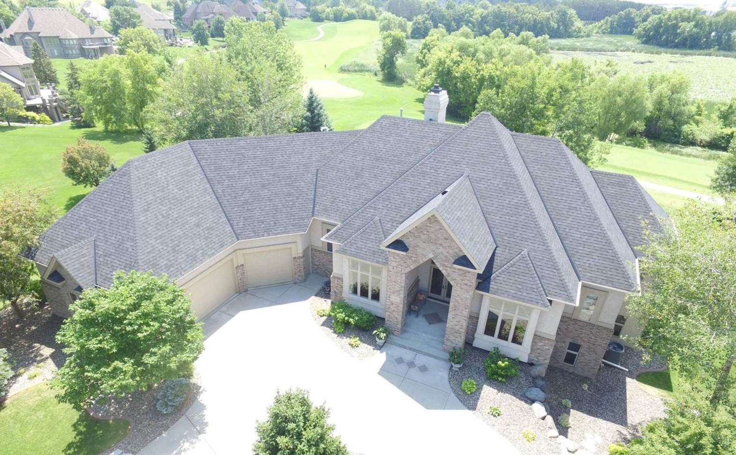 Aerial view of a finished gray shingle roof on a large Red Wing, MN home, September 2025