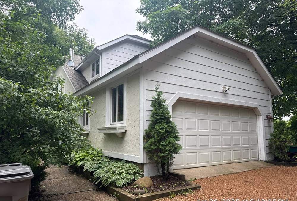 Garage and roofline of a Waconia home near Lake Waconia, photographed during a roof project, June 2025