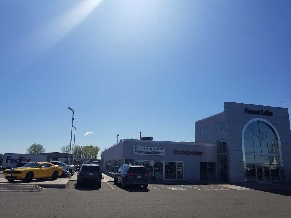 Forest Lake Chrysler Jeep Dodge showroom in Forest Lake, MN, under a clear sky, the building Repair King re-roofed with Duro-Last PVC
