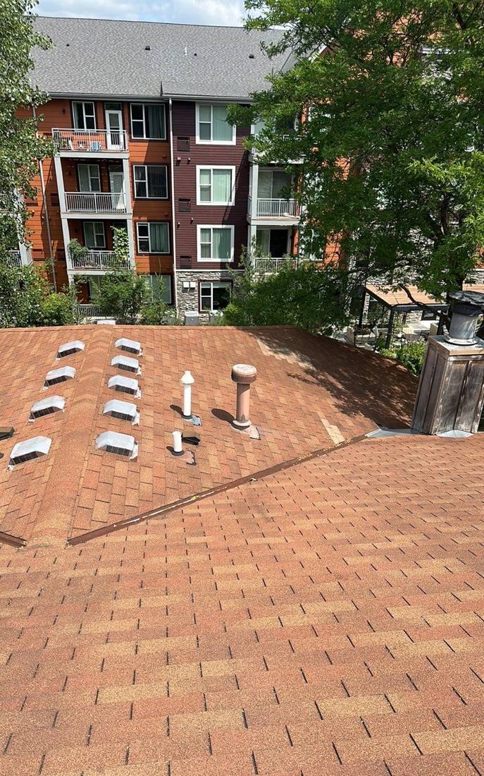 Aerial view of a Prior Lake roof with a neighboring condo building, July 2023