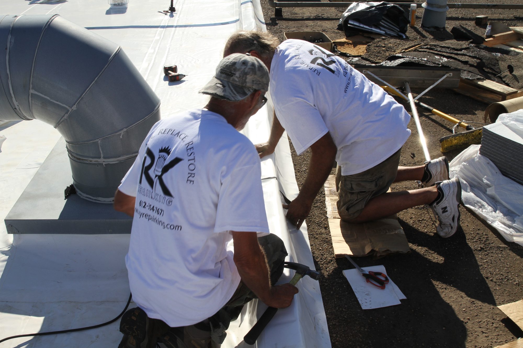 Repair King crew sealing a commercial flat roof membrane