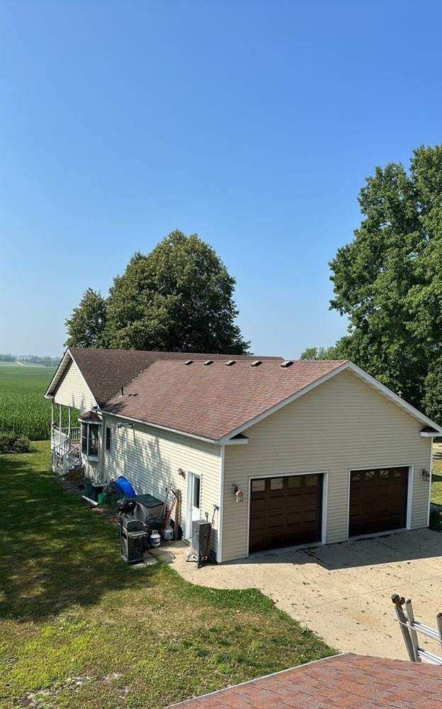 Aerial view of a Dennison-area home and attached garage after a roof project, July 2023