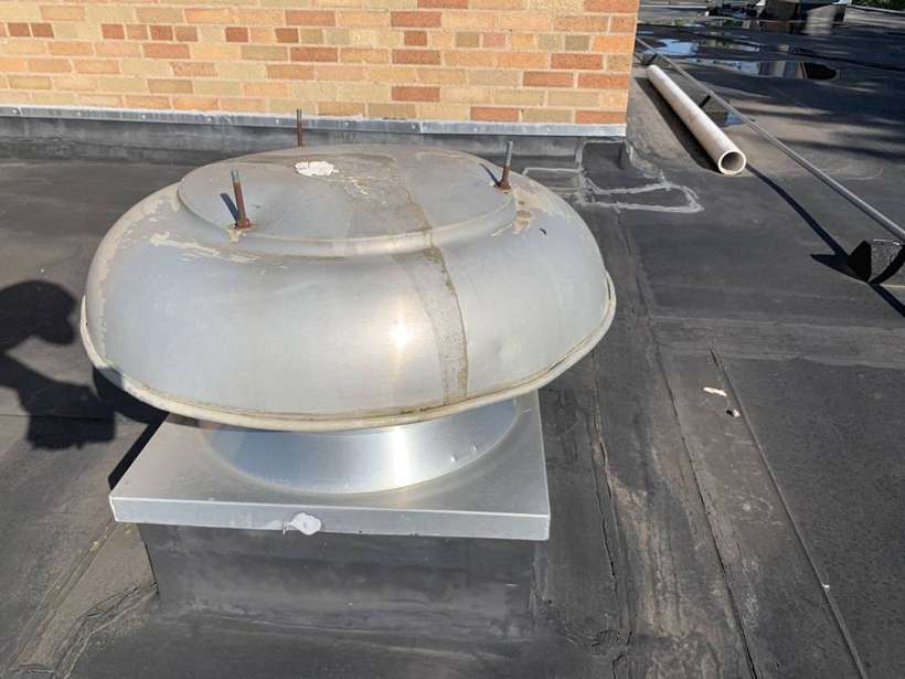 A rooftop exhaust fan on the Washington Place flat roof, St. Cloud
