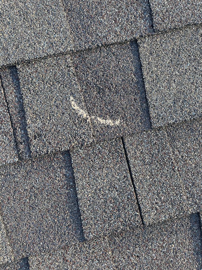 Chalk-marked hail hit on a GrandStay shingle, Waseca