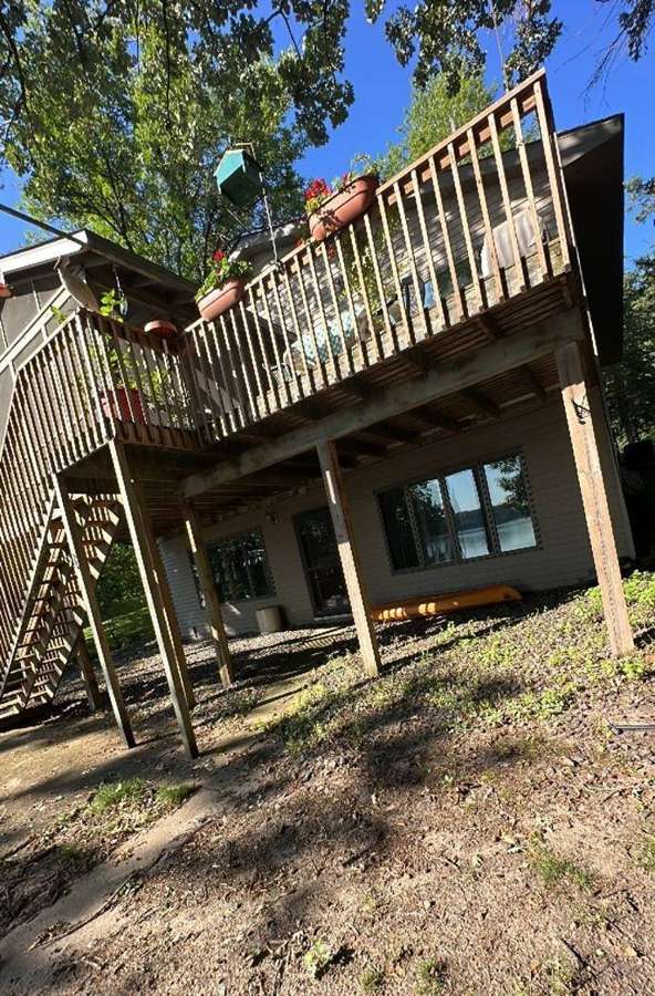 Two-story lake home with a tall rear deck on Irvine Avenue NW in Annandale, MN, July 2023