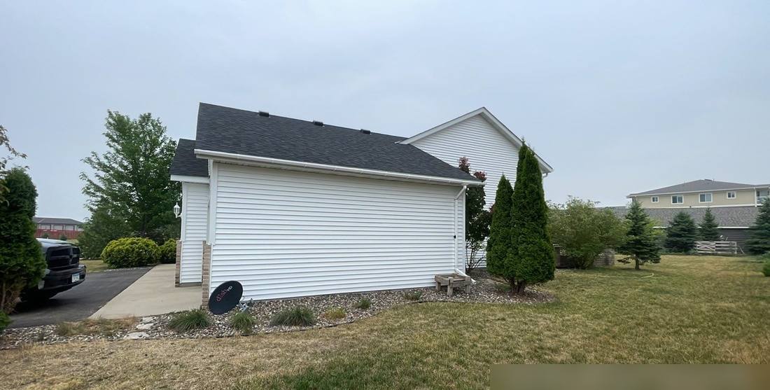 Side of a Sartell home photographed during a roof inspection, June 2023