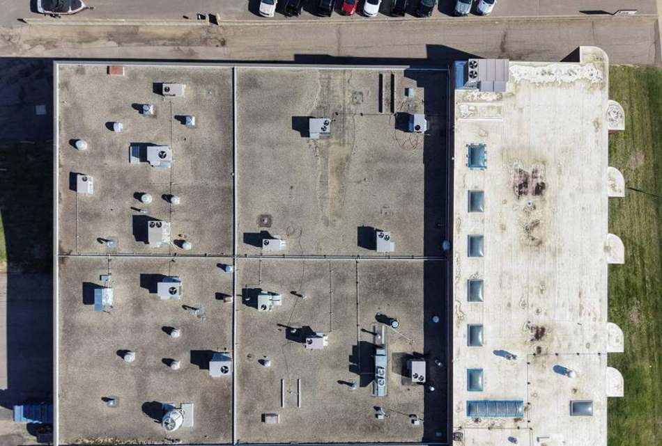 Aerial view of the sectioned low-slope commercial roof at Safe Reflections in Stillwater, MN, April 2026