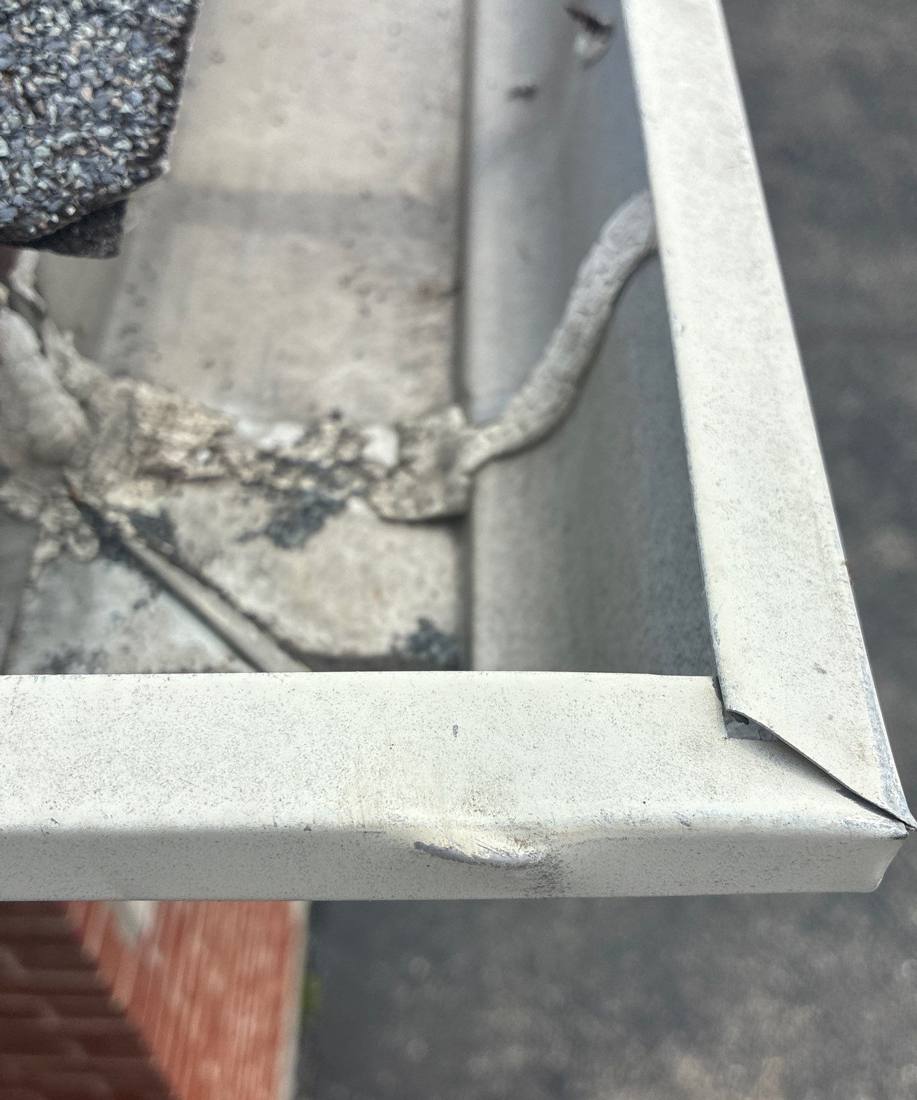 Skylight flashing and shingles on a Naperville roof during an inspection, May 2026