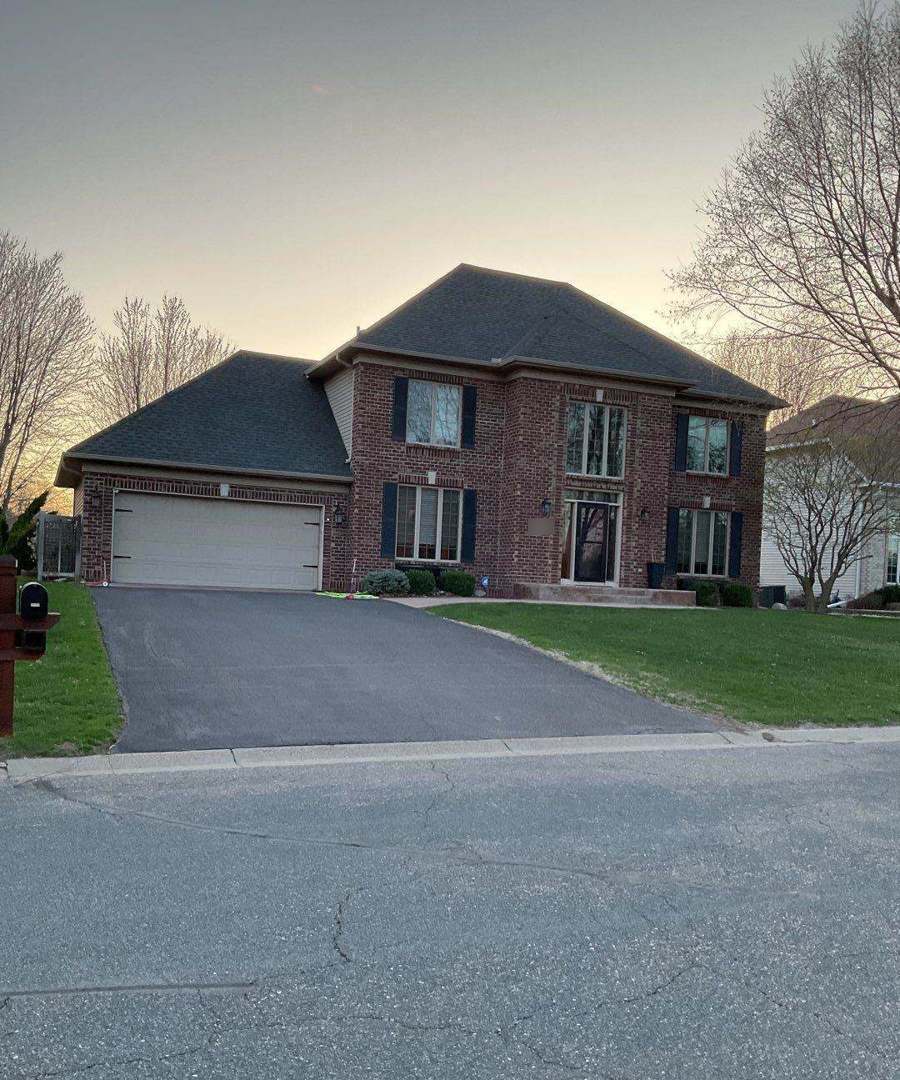 Two-story brick home in Savage, MN photographed by Repair King during a 2023 roof inspection