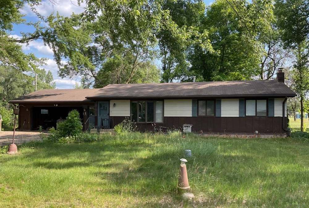 Ranch-style home near Hastings photographed during a roof inspection, July 2023