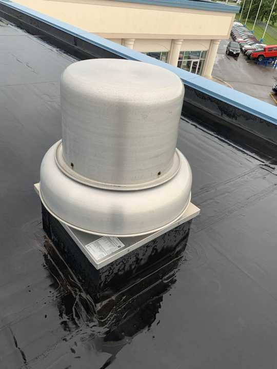 A rooftop exhaust fan checked for dents on the Eide Chrysler roof in Pine City, July 2019