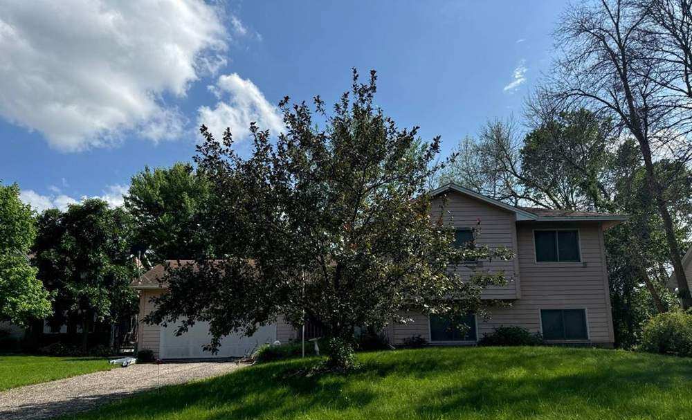 Two-story home in Maple Plain photographed during a roof inspection, June 2024