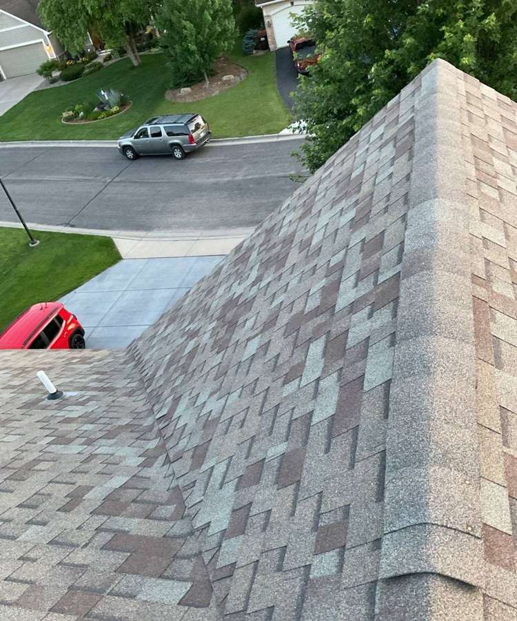 View from the ridge of a Cottage Grove home over a newer subdivision street during a July 2023 hail inspection
