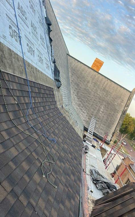 New shingles on the church's steep lower slope, with the old roof above, St. James, July 2023