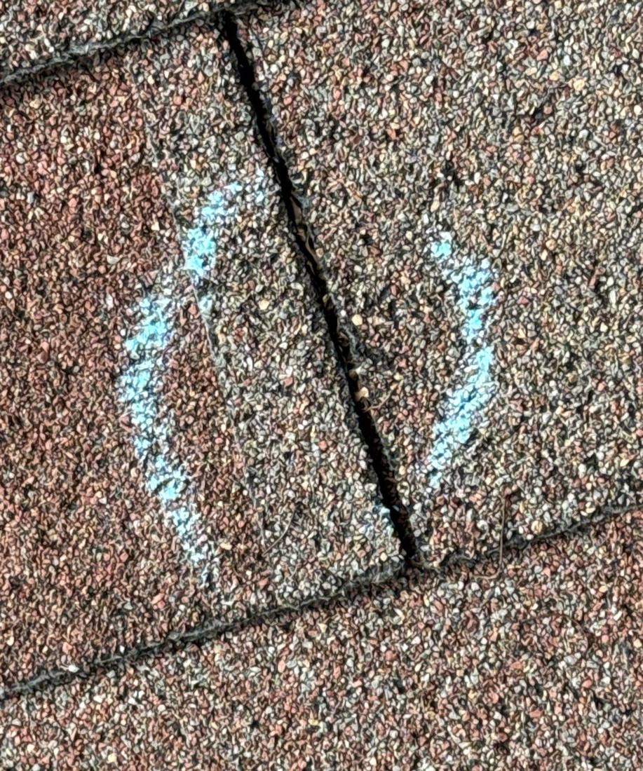 Hail hit chalk-marked on a Minnetonka roof slope during an inspection, May 2024