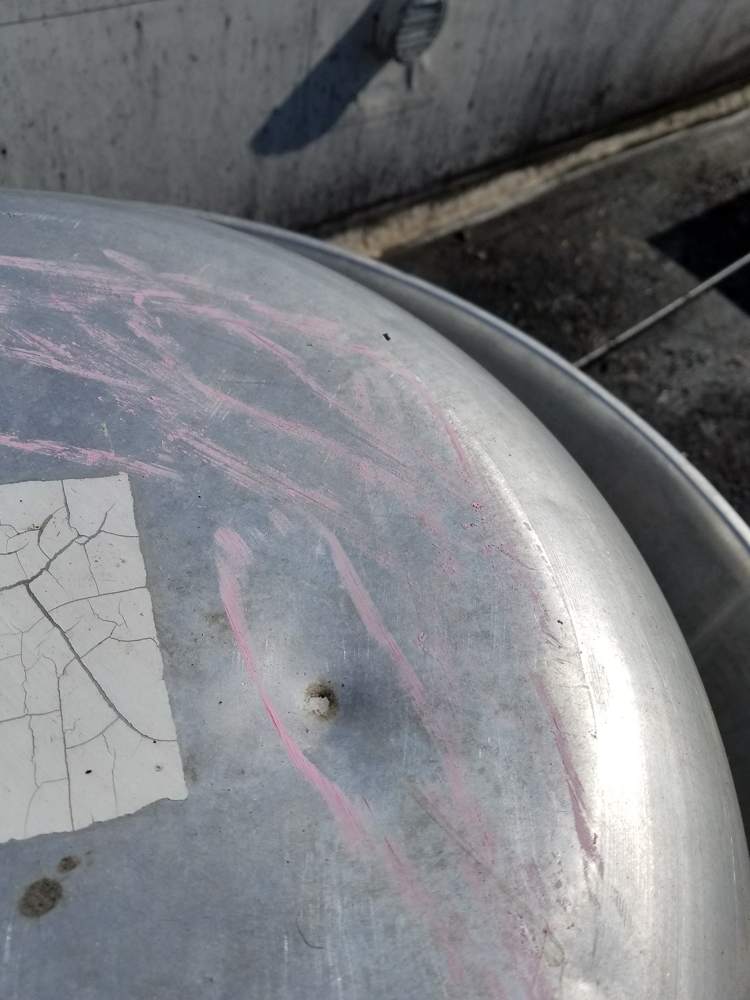 A dented exhaust fan cap, chalk-marked during our Good Earth roof inspection in Roseville