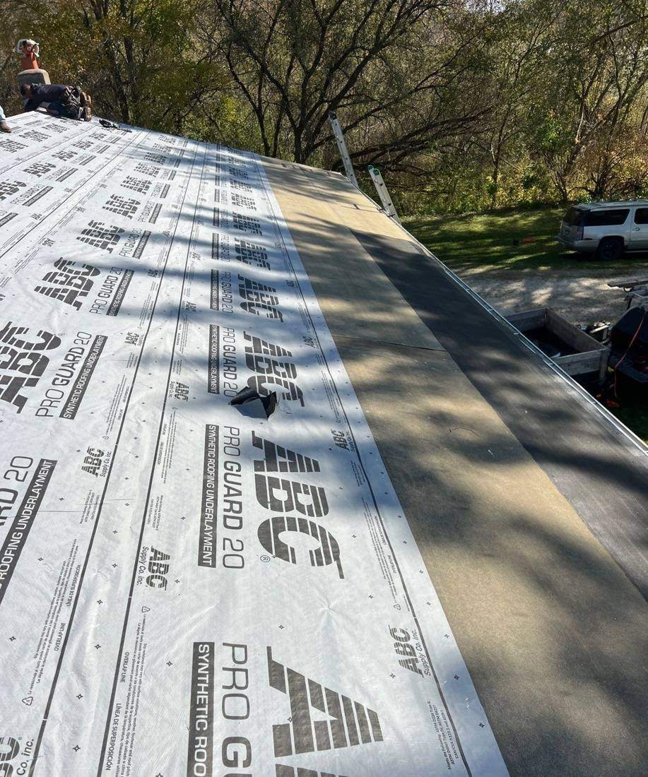 Synthetic underlayment going down during a tear-off near Minnesota City, October 2024