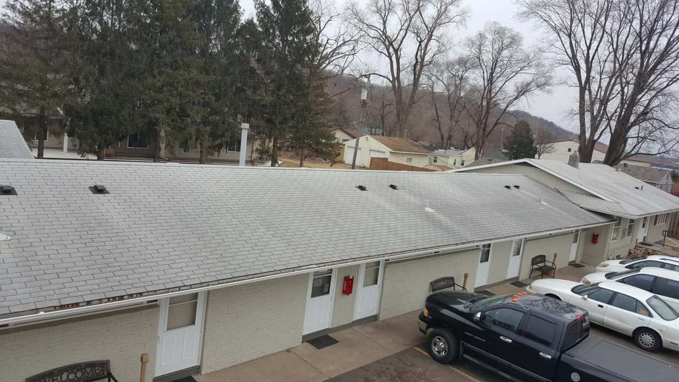Red Rock Lodge on Hastings Avenue in Newport, MN, a long single-story motel with a shingle roof, photographed by Repair King during a roof inspection