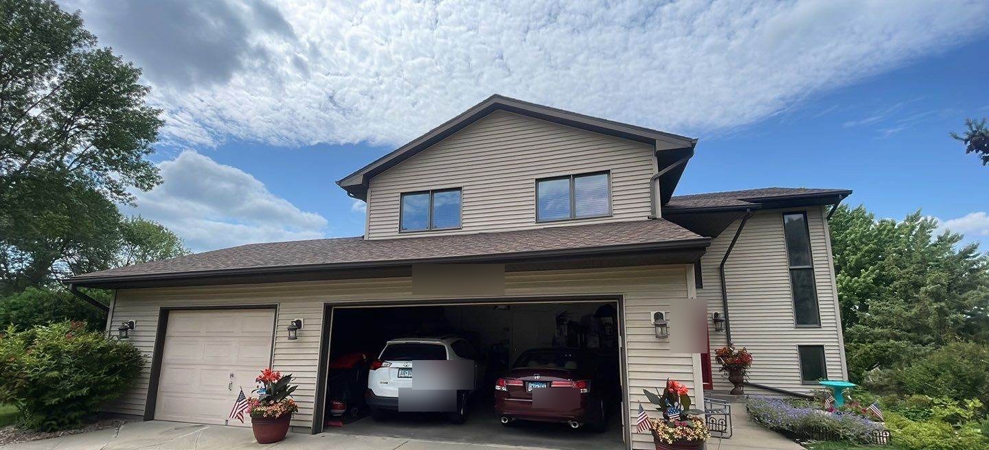 Two-story home in Lakeville, MN photographed by Repair King during a roof inspection, July 2023