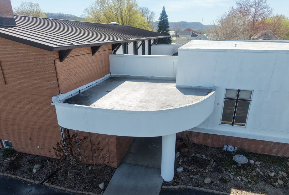 Aerial view of Bethany Lutheran Church's brick building and flat roof in Lake City, MN, photographed by Repair King during a roof inspection