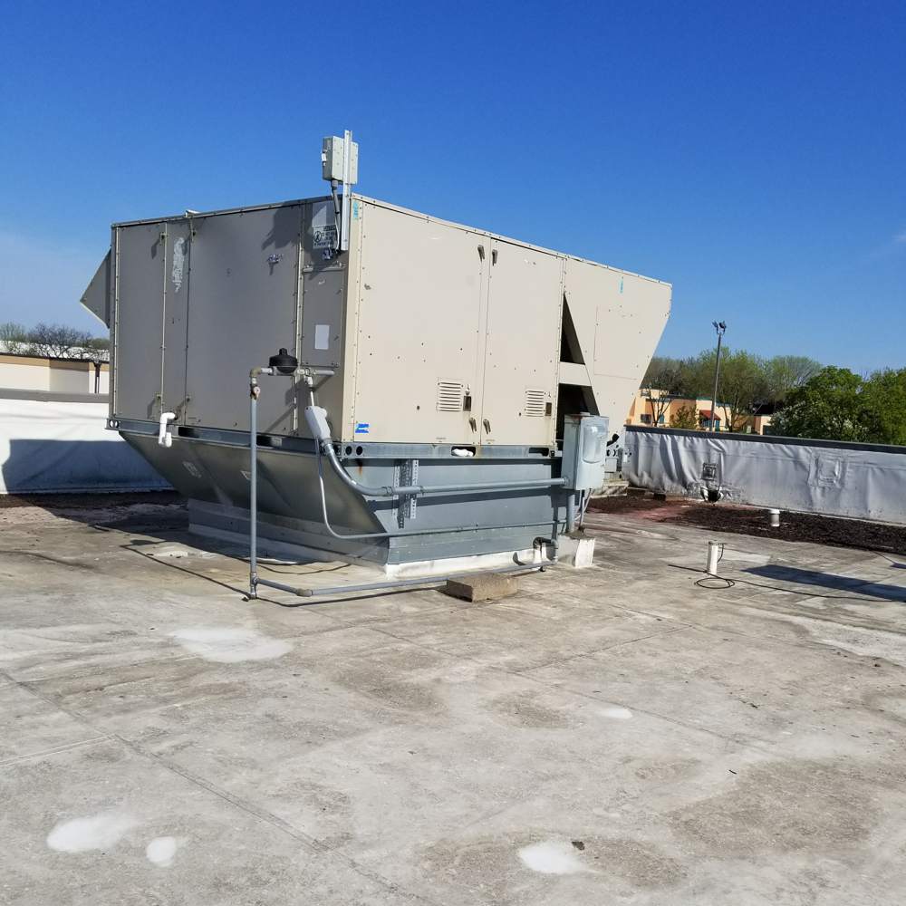 Rooftop HVAC unit and white flat roof membrane on the Good Earth restaurant building on Highway 36 in Roseville, MN, during a Repair King inspection