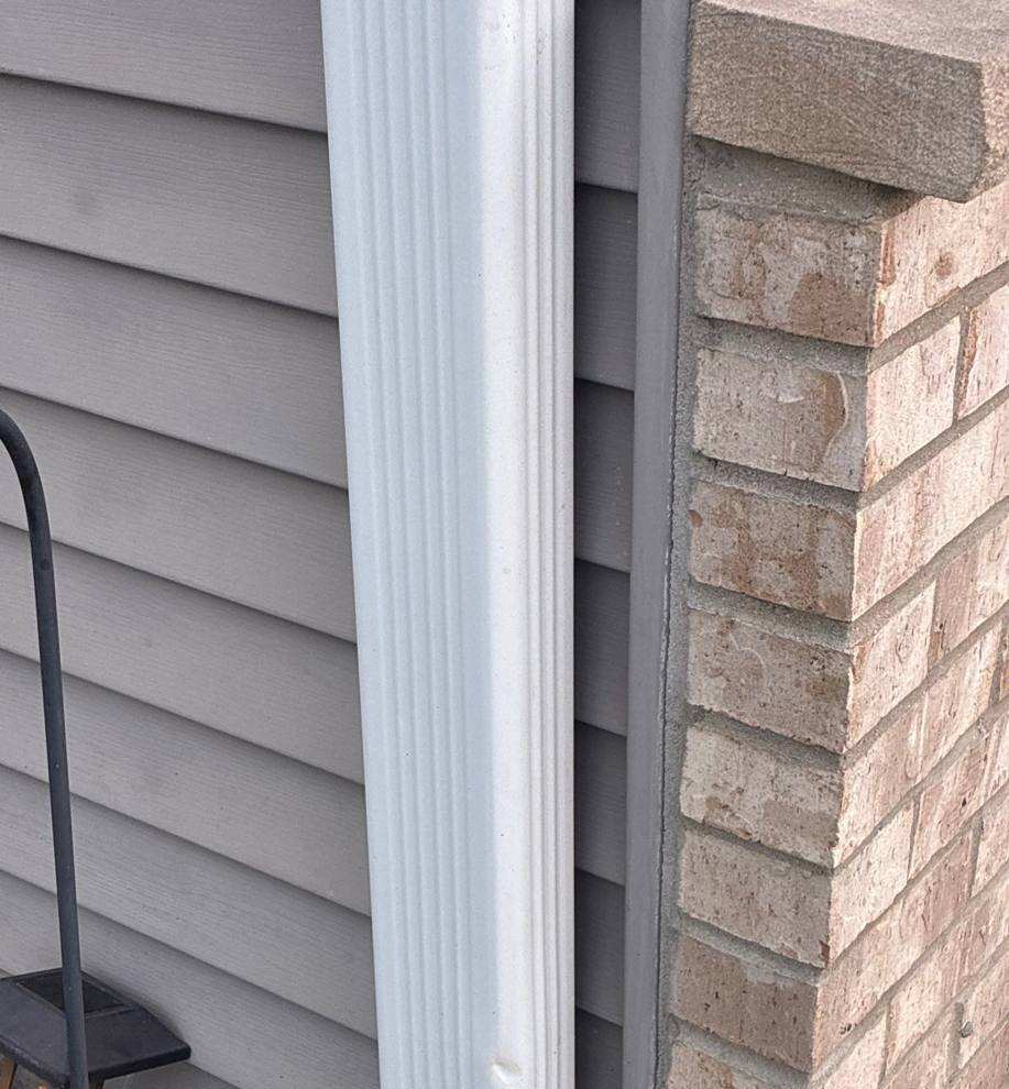 Gutter and downspout detail at a Faribault home, April 2026