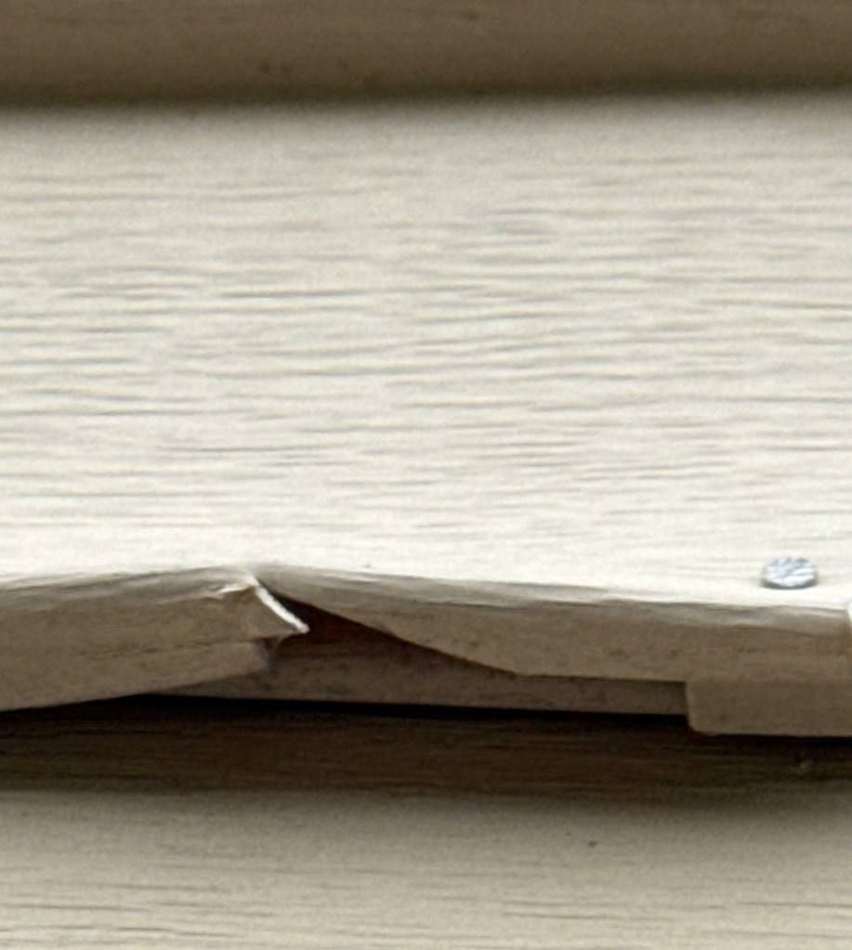 Cracked vinyl siding course on a Blaine home, September 2025