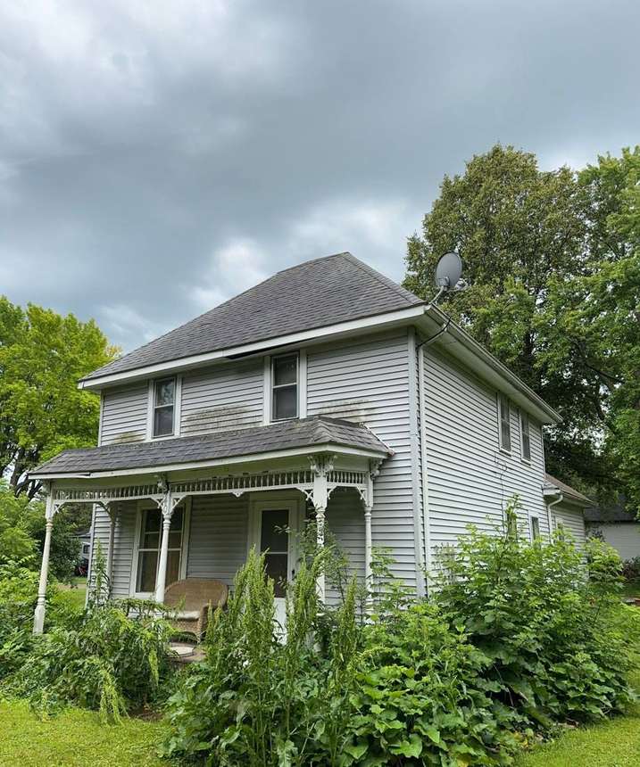 Two-story farmhouse-style home in Cokato photographed during a roof project, July 2024