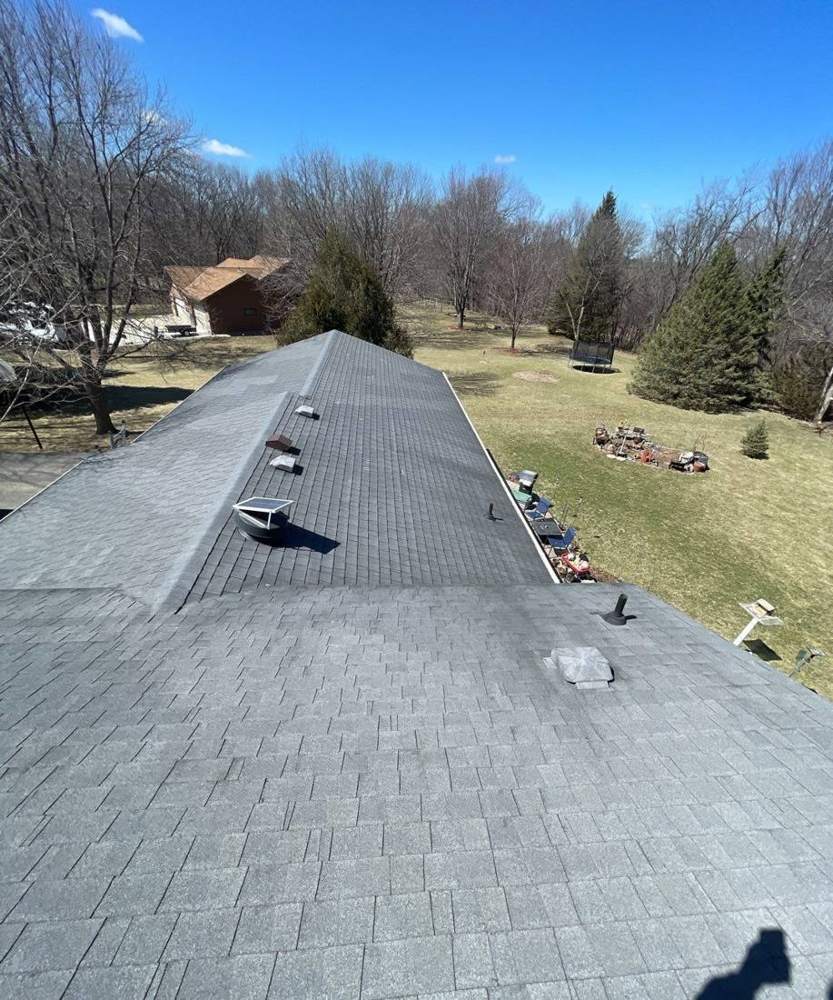 View down a steep roof ridge line at a Mankato-area property, April 2022
