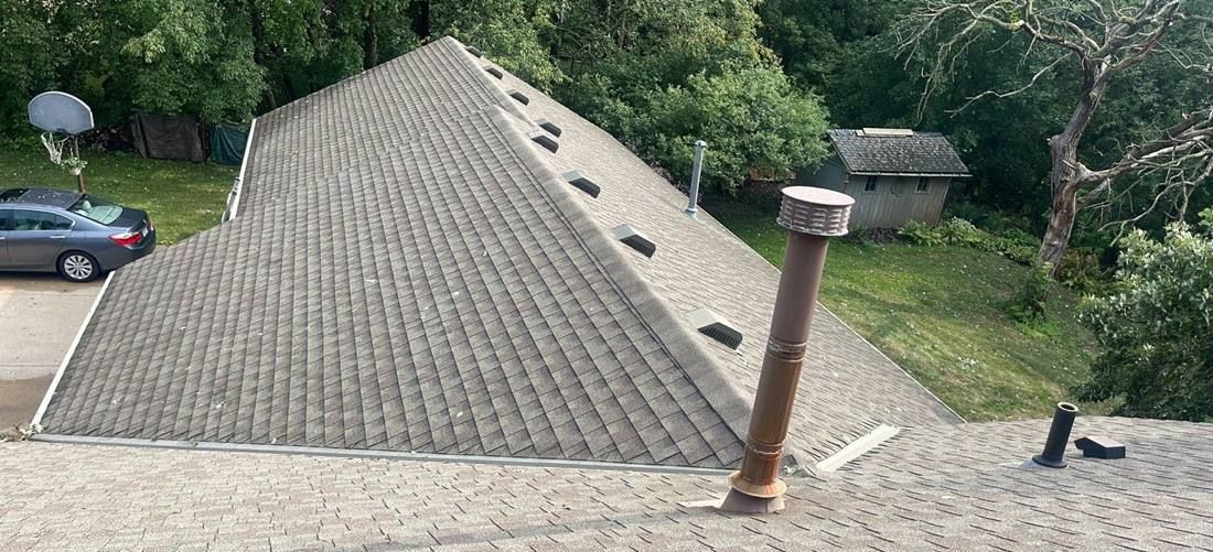 Aerial view of a Rosemount roof valley and chimney flashing, July 2023