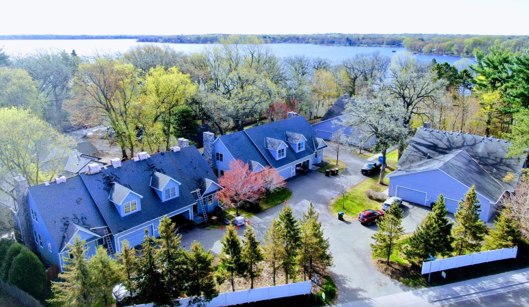 New roofs on lakeside homes in the Twin Cities, aerial photo