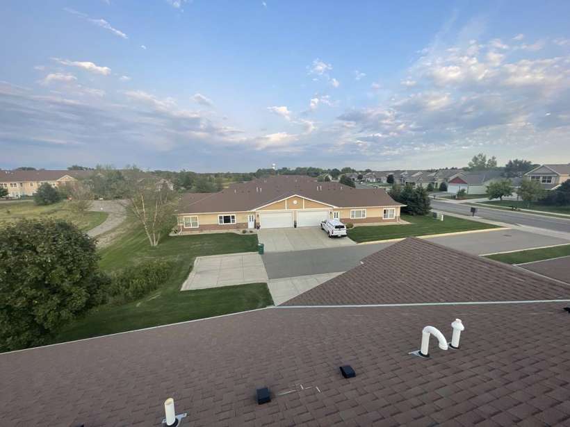 View from a Pinecone Villas townhome roof in Sartell, MN, looking over neighboring townhomes, during a September 2021 Repair King inspection