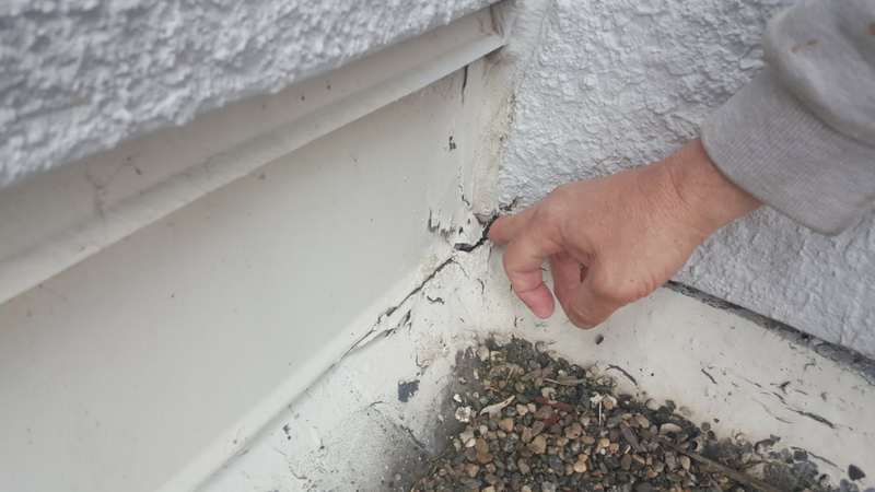 Cracked flashing where the old roof met the parapet wall at the Forest Lake dealership