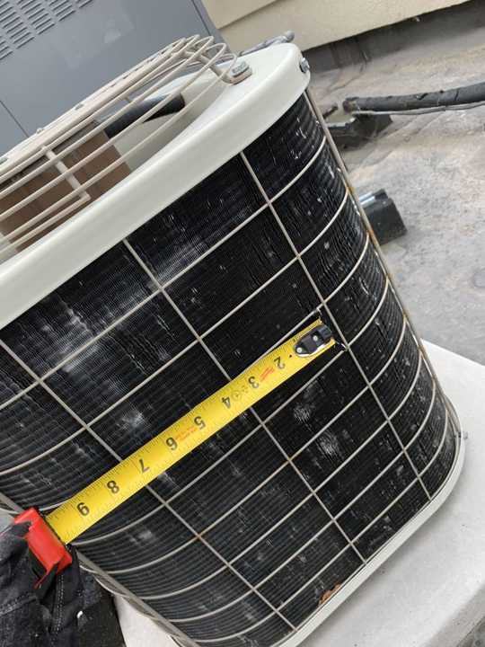 A tape across the dented fins of a rooftop condenser at the Hilton Garden Inn in Maple Grove, May 2019
