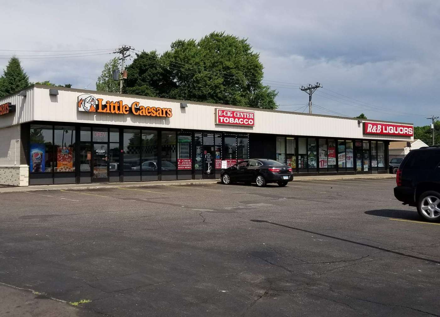 The Little Caesars, E-Cig Center Tobacco and B&B Liquors strip center on South Robert Street in West St. Paul, MN, whose flat roof Repair King inspected