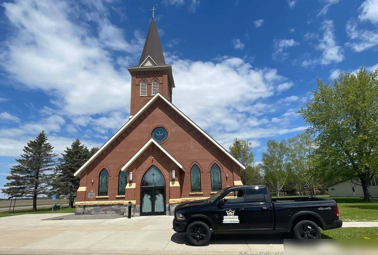 St. Stanislaus Kostka Church in Bowlus, MN, with a Repair King truck parked out front during a May 2022 roof inspection