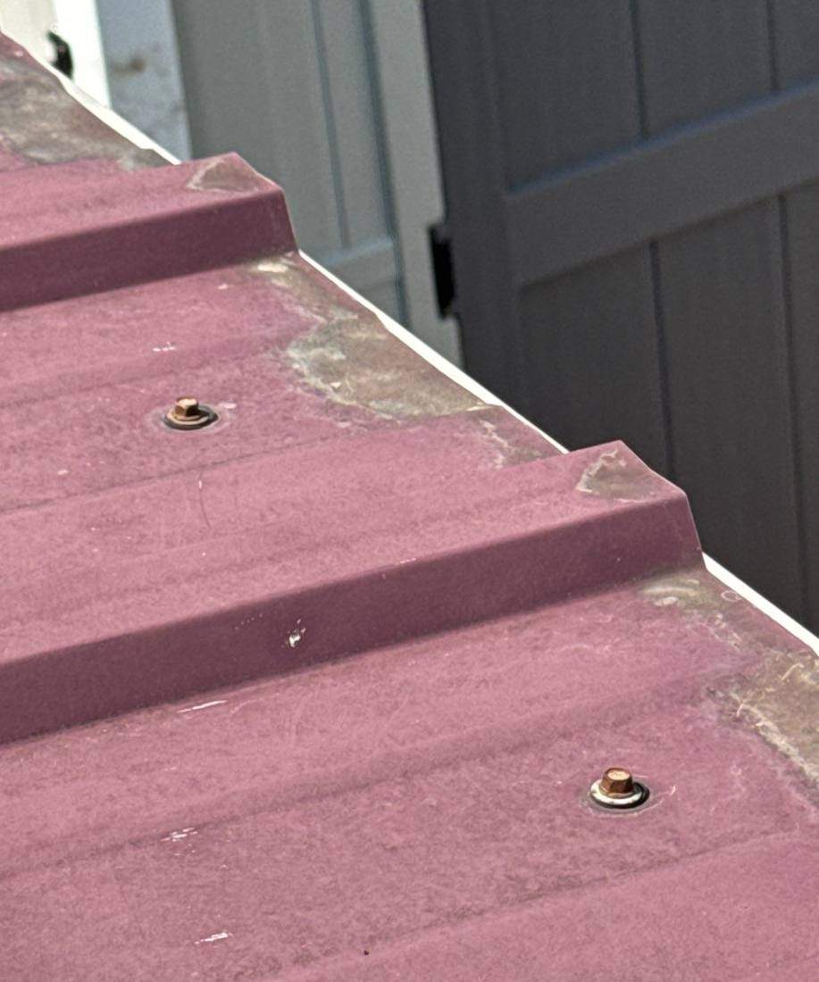 Fasteners on a standing-seam metal roof during a Goodview inspection, July 2024