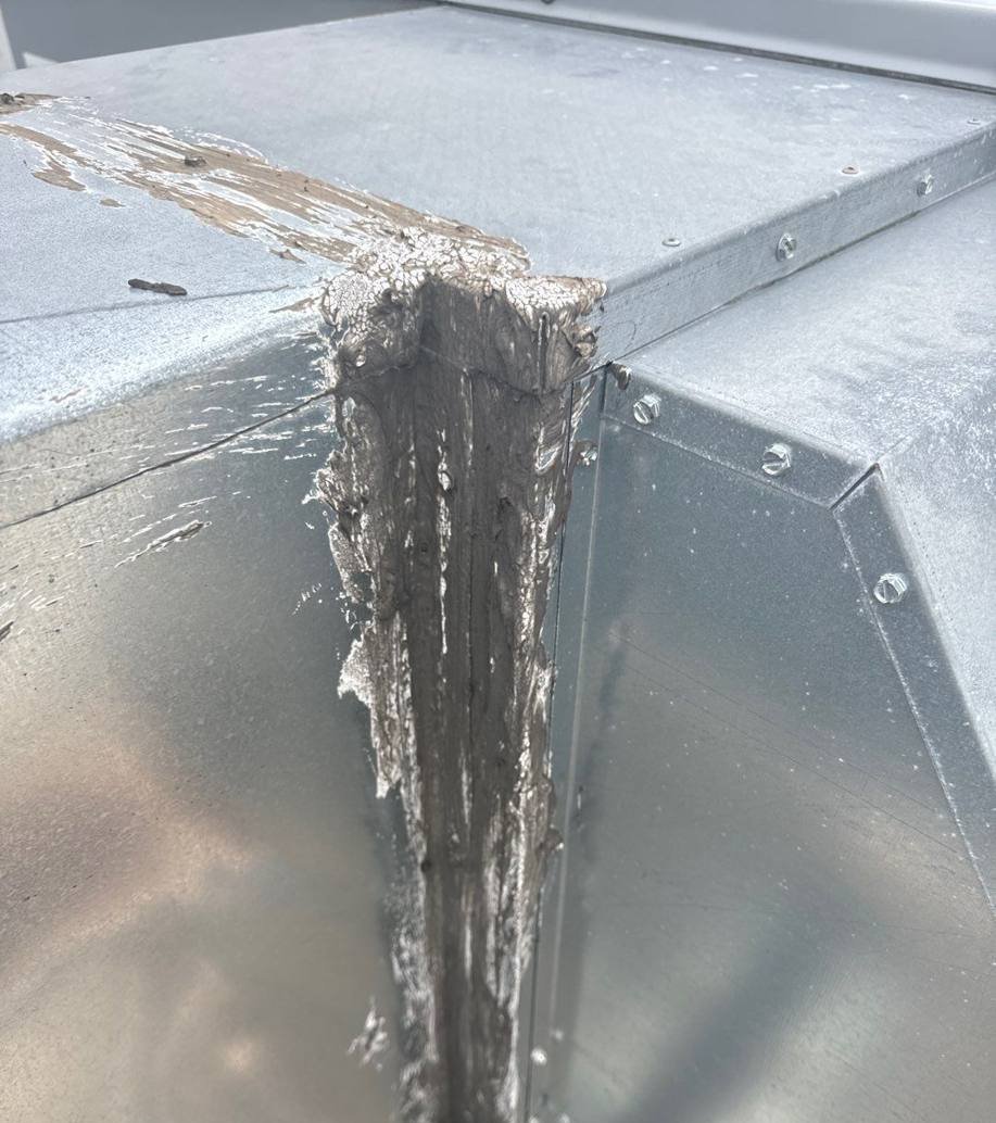 Open flashing seam at a rooftop curb on the Bloomington Lincoln roof, July 2024