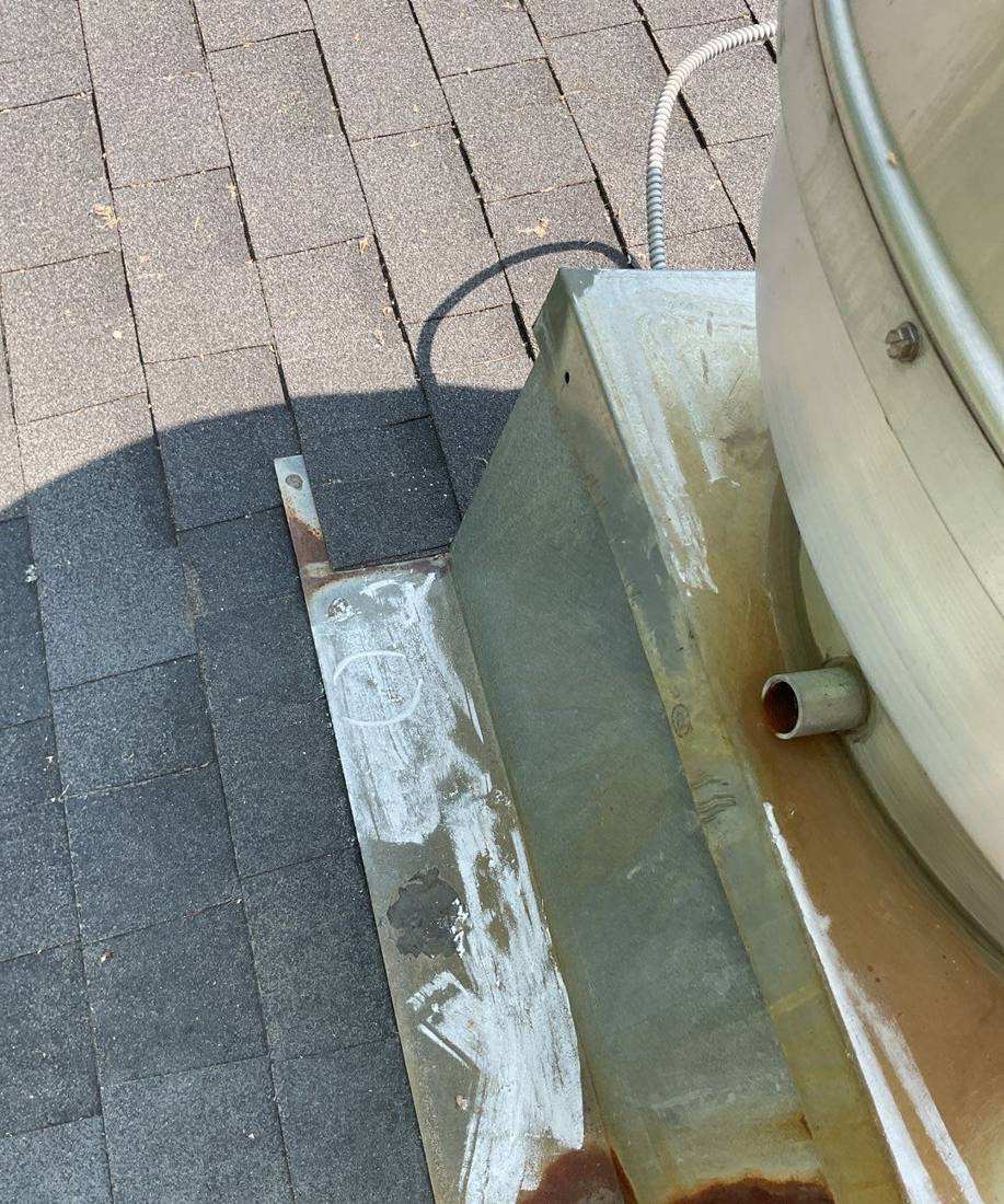 Rusted rooftop vent base on the AmericInn hotel roof, June 2023