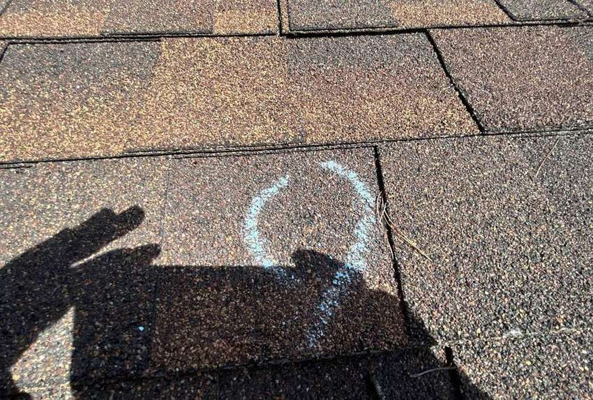 Hail hit chalk-marked on a north Minneapolis roof during an inspection, September 2025