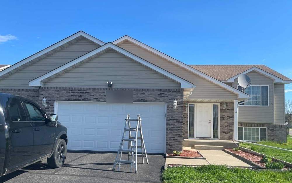 Ranch-style Big Lake home with ladder set for a roof inspection, May 2022