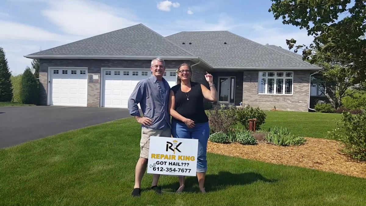 Dean and Ginger Ward in front of their finished Repair King roof and new garage doors, Lakeville address, spring 2019