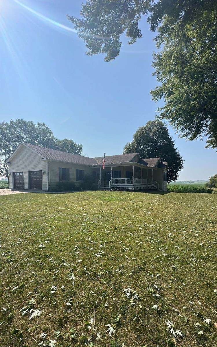 Farmhouse with attached garage on the edge of Dennison, MN photographed by Repair King during a roof project
