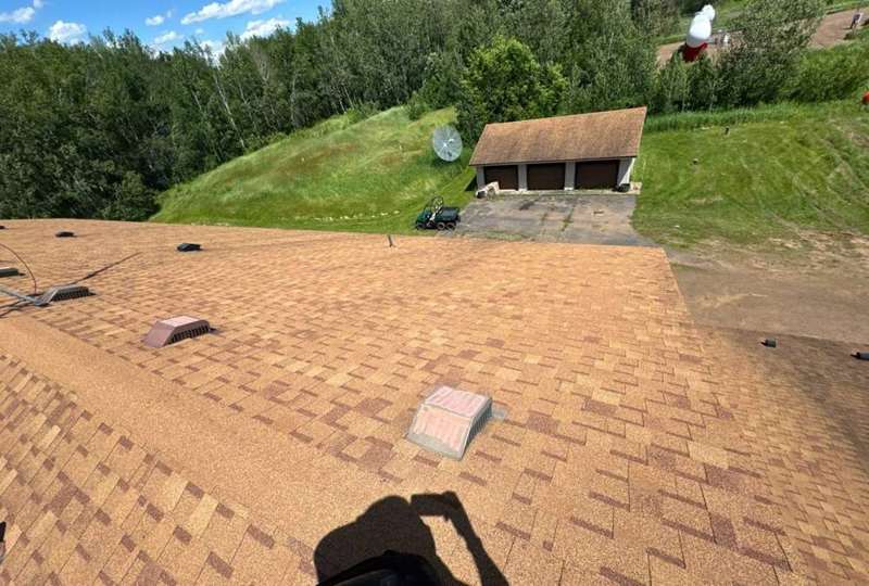Garage roof and yard on a Finlayson property near Highway 23, June 2024