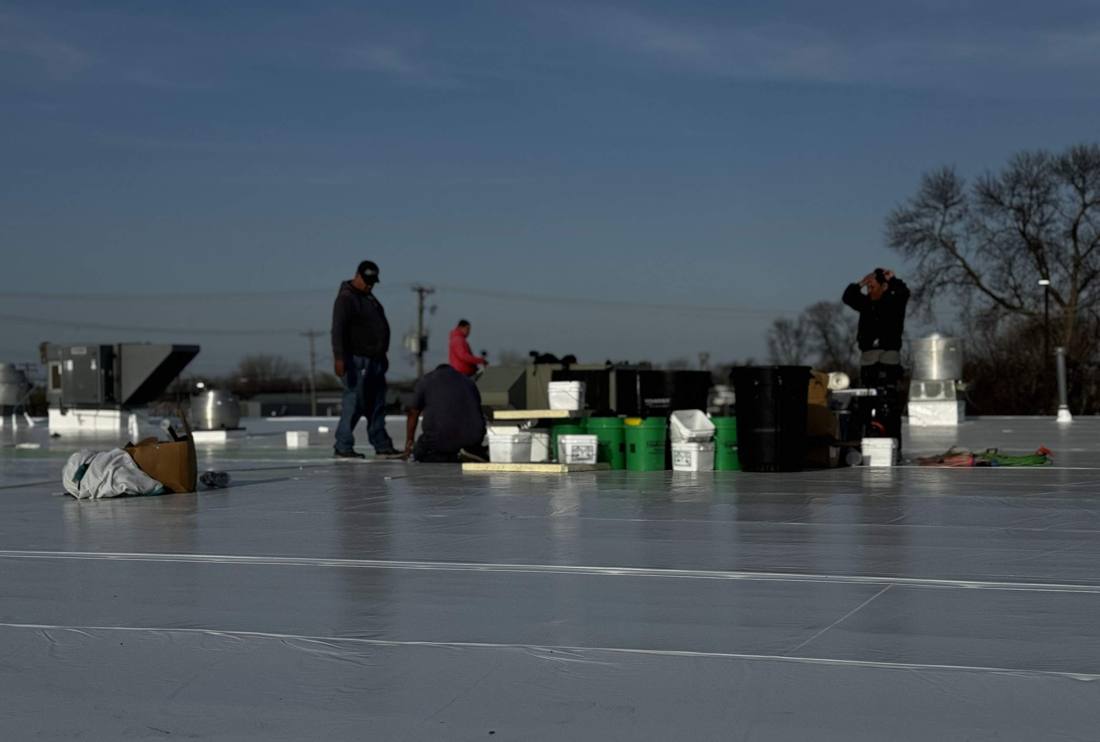 Repair King crew on The Marketplace roof in Cokato, April 2024