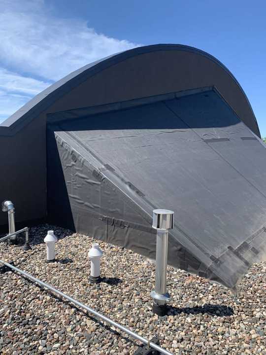 The curved roof feature and ballasted rubber roof at Paradise Car Wash in Maple Grove, MN during a Repair King inspection in August 2019